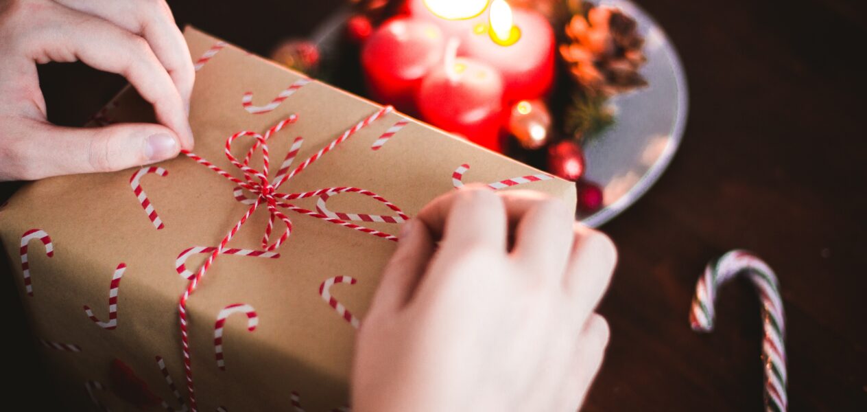 Close up view of a pair of hands unwrapping a gift