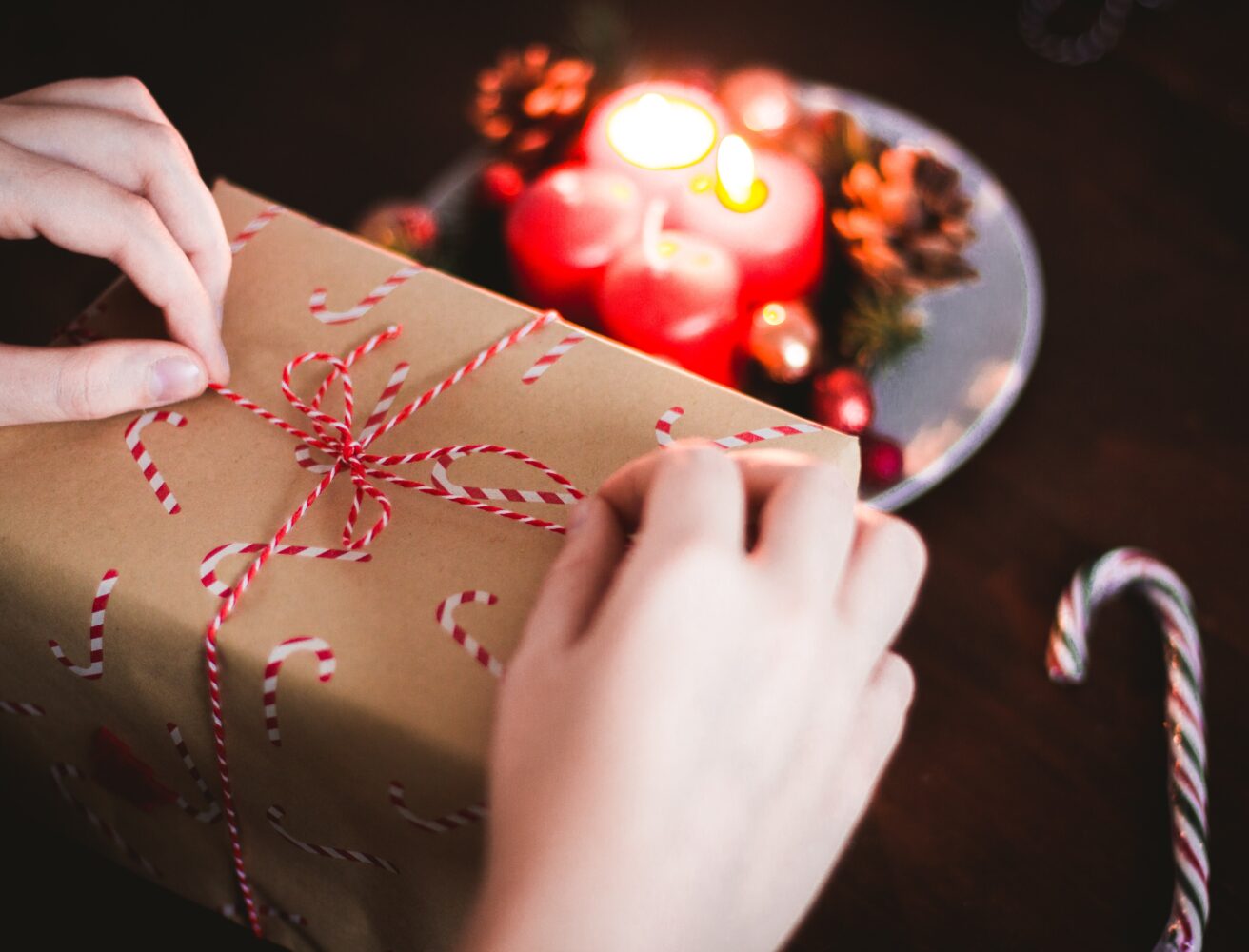 Close up view of a pair of hands unwrapping a gift