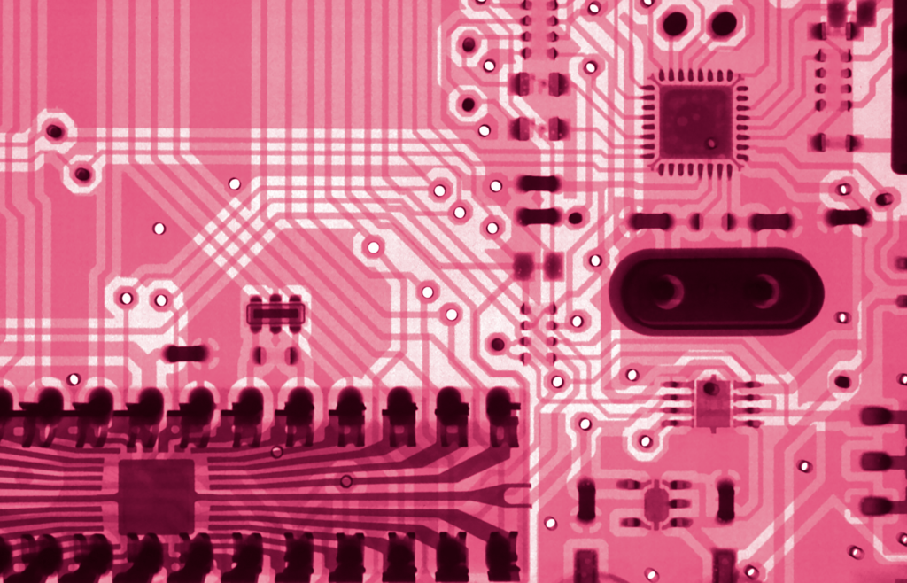 Zoomed view of a pink-toned circuit board representing technology for Integral at Agile & Beyond 2024.